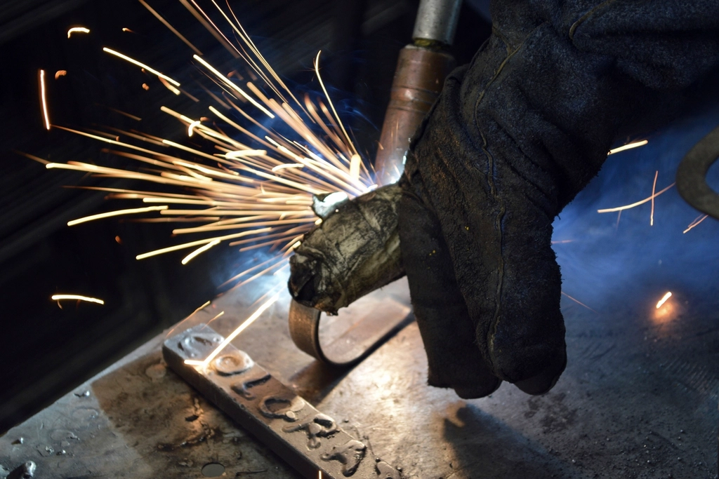 Metal fabrication in progress. Sparks from a cutting tool on steel.